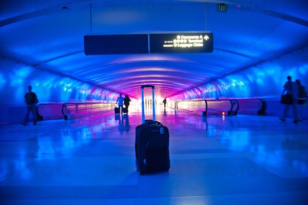 Abandoned suitcase in blue airport terminal