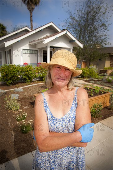 Portrait of smiling Caucasian woman posing near house