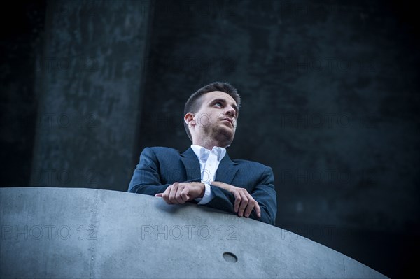 Low angle view of businessman leaning on balcony