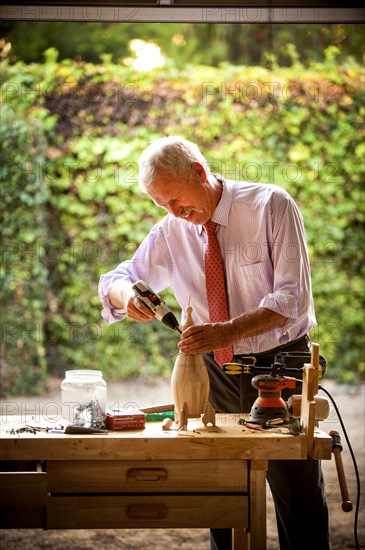 Man building birdhouse in garage