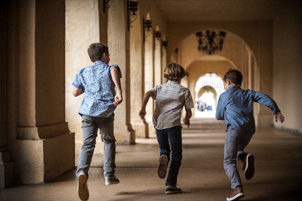 Brothers running near pillars