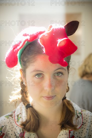 Serious Caucasian girl wearing Christmas decoration on head