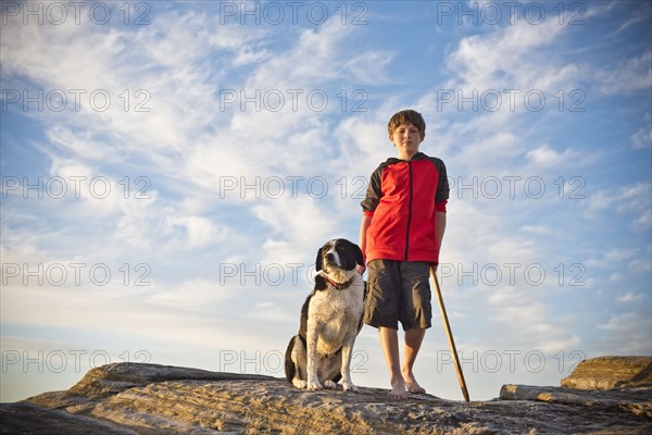 Caucasian boy hiking with dog