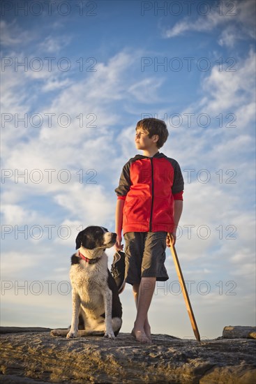 Caucasian boy hiking with dog