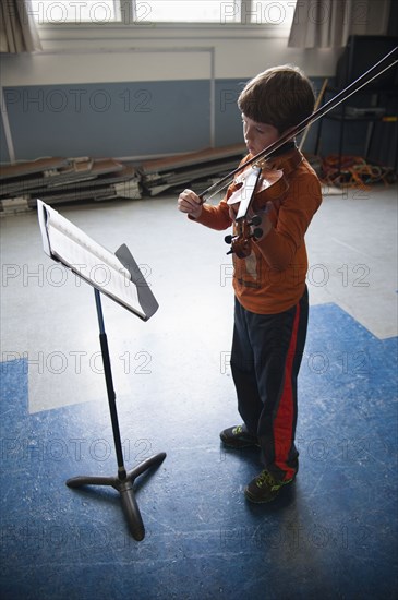 Caucasian boy practicing violin