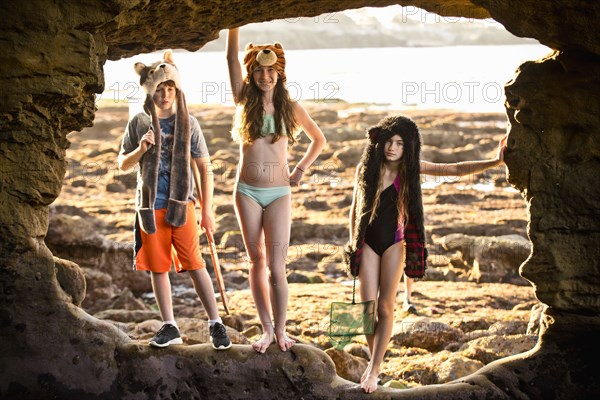 Portrait of Caucasian boy and girls hiking on rocks at beach