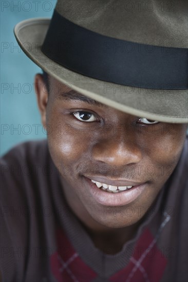 Smiling mixed race man in fedora