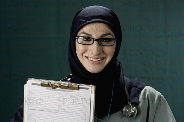 Middle Eastern doctor holding medical chart