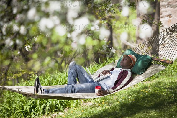 Black man laying in hammock