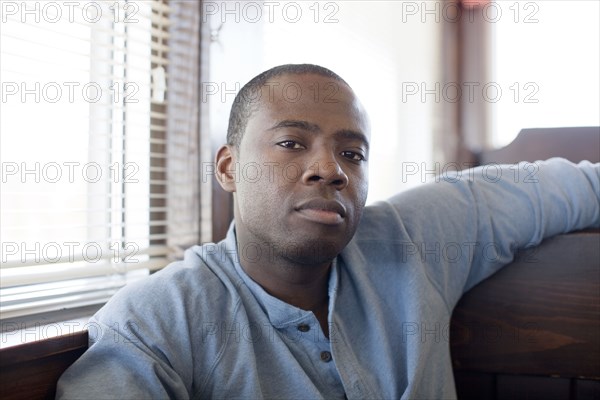 Black man sitting in booth at diner