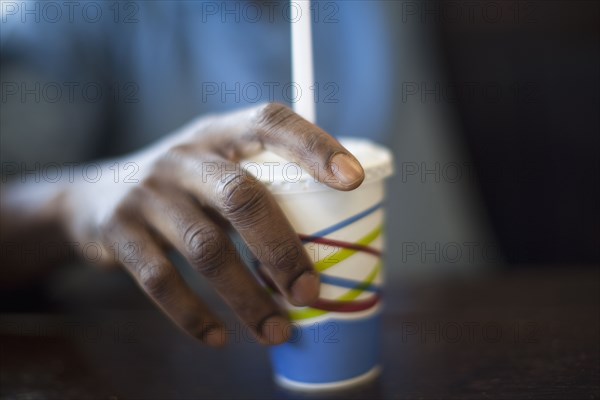 Black man holding soda cup