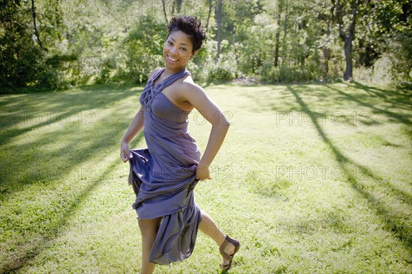 Black woman walking across lawn