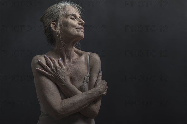 Portrait of daydreaming older Caucasian woman