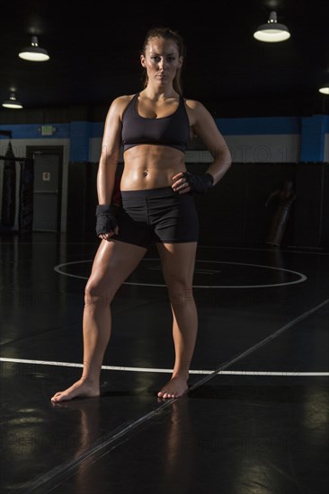 Caucasian fighter standing in gym