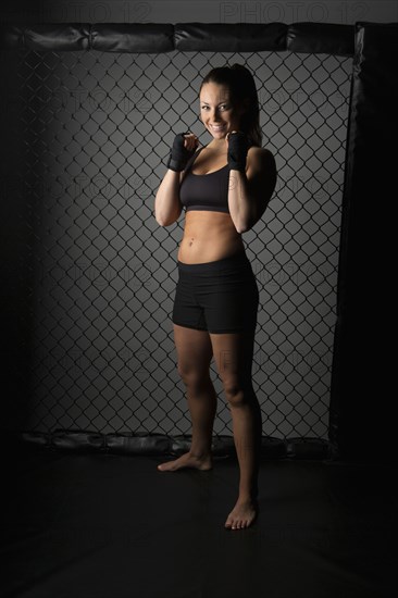 Caucasian fighter standing in gym