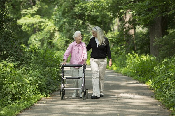 Caucasian mother and daughter walking in park