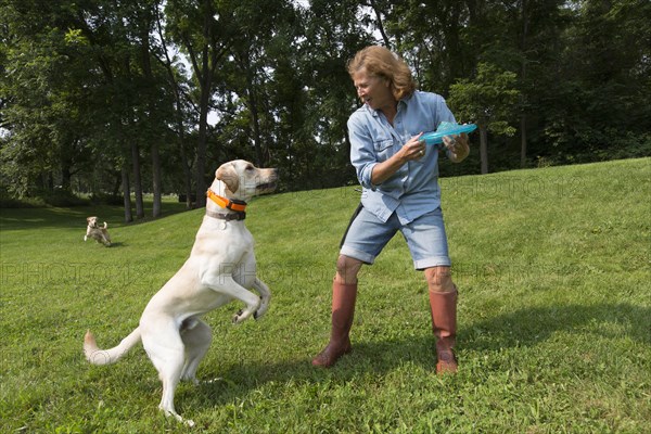 Caucasian woman playing with dog in park