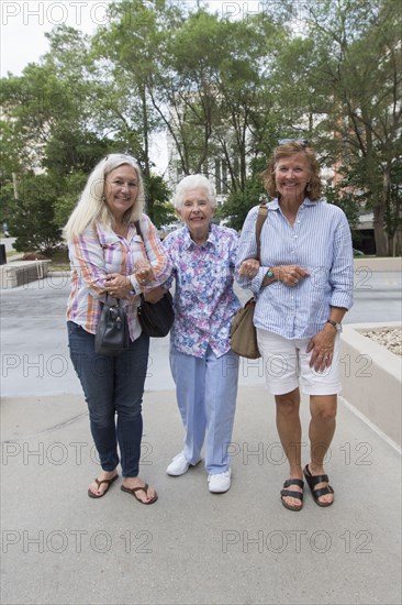 Caucasian mother and daughters walking together