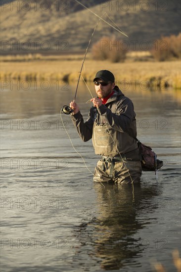 Fisherman casting in river