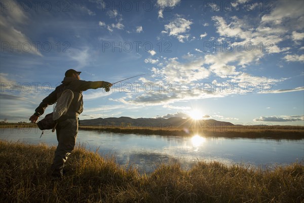 Fisherman casting in river