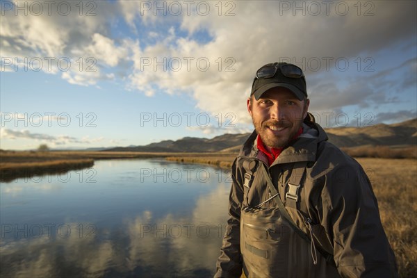 Smiling man standing near river