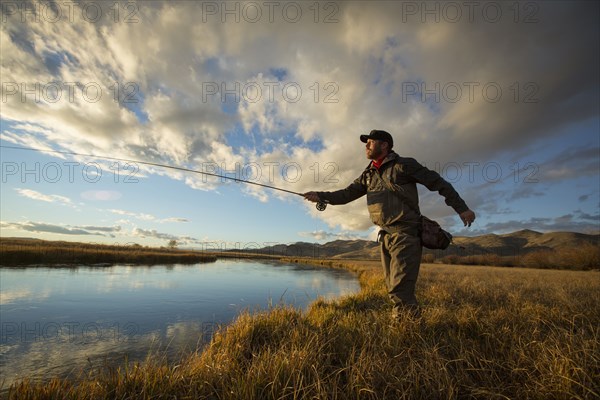 Fisherman casting in river