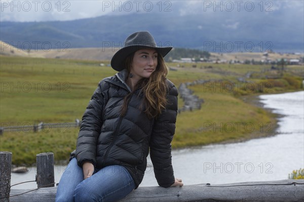 Caucasian woman sitting at rural river