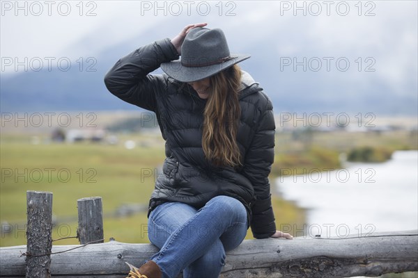 Caucasian woman sitting at rural river