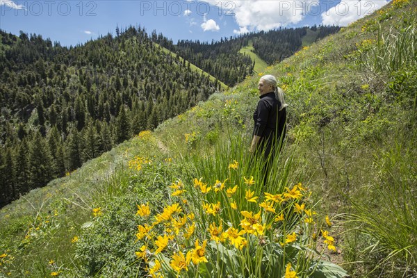Caucasian woman walking on remote hillside