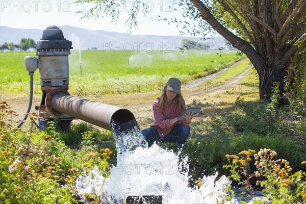 Caucasian farmer checking water pump