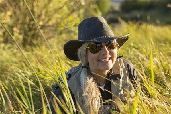 Caucasian woman smiling in tall grass