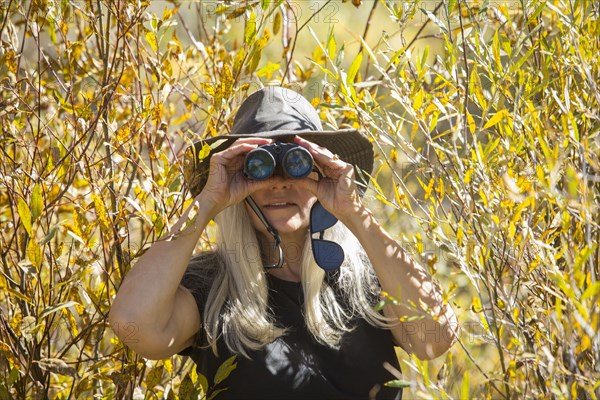 Caucasian woman using binoculars