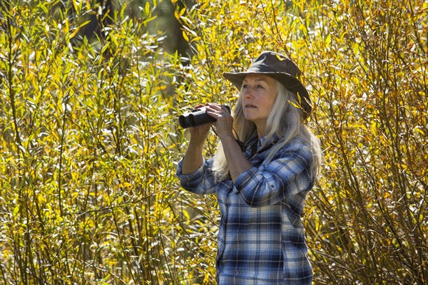 Caucasian woman using binoculars