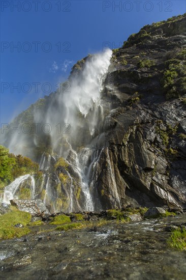 Waterfall pouring over remote cliff