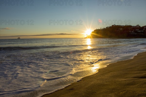 Sunset over horizon at remote beach