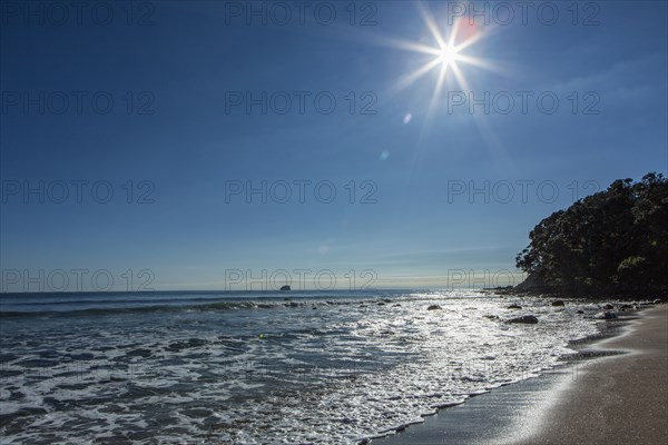 Sun over horizon at remote beach