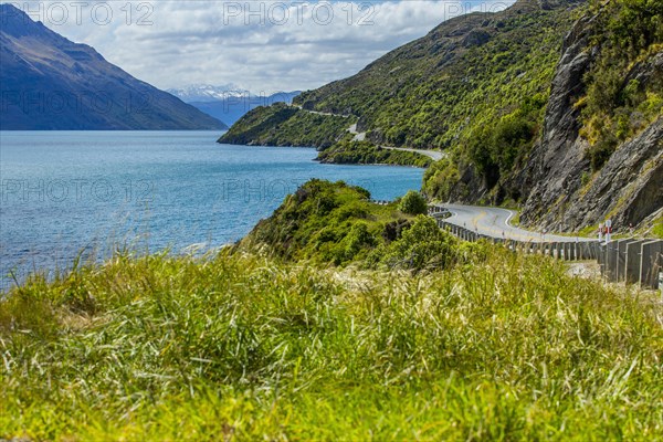 Highway on remote mountains near lake