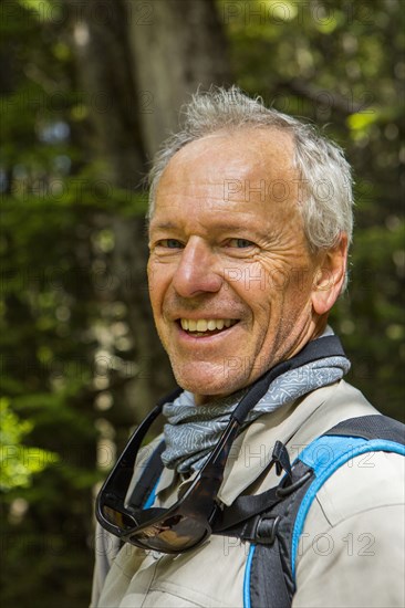 Caucasian hiker smiling in forest