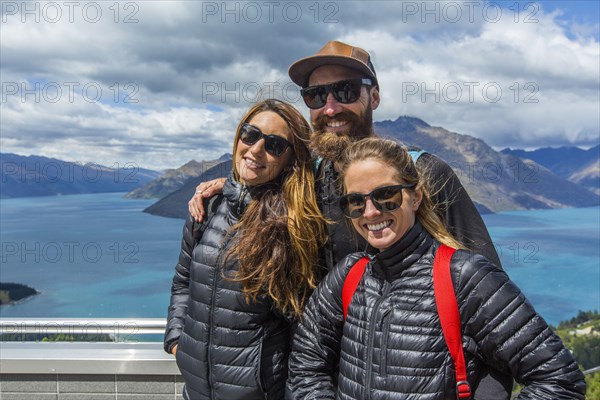 Hikers smiling at scenic viewpoint