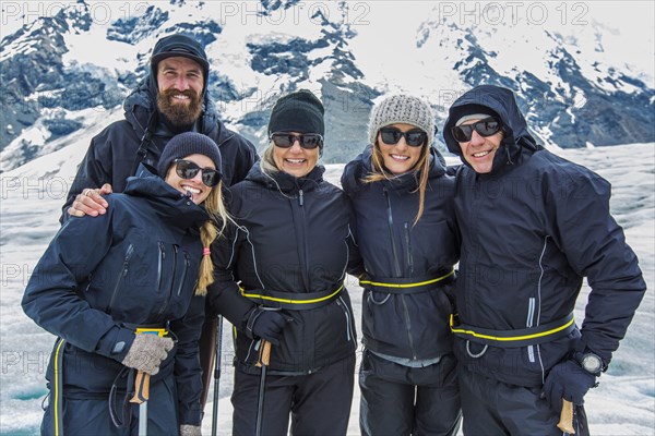 Caucasian cross-country skiers smiling in snowy landscape