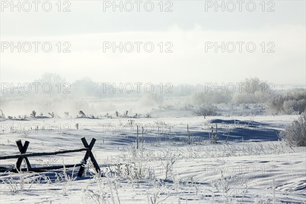 Fences in snowy rural landscape
