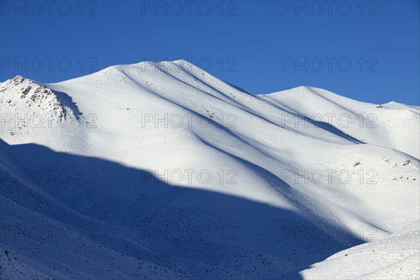 Snowy mountains in remote landscape