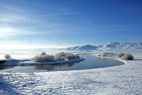 Snowy mountains and river in remote landscape