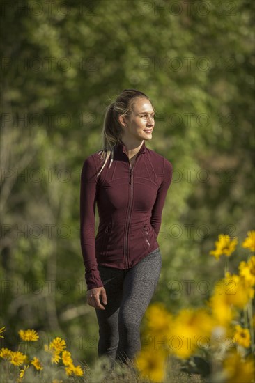 Caucasian woman standing in flowers