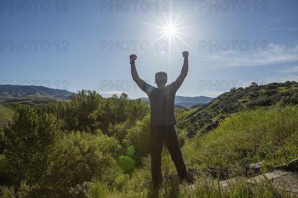 Caucasian man celebrating on mountain