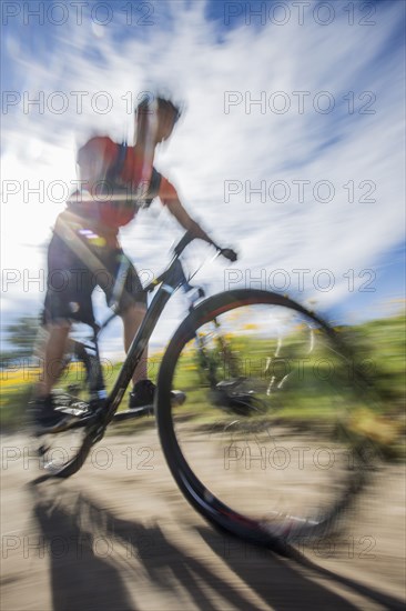 Blurred view of man riding mountain bike