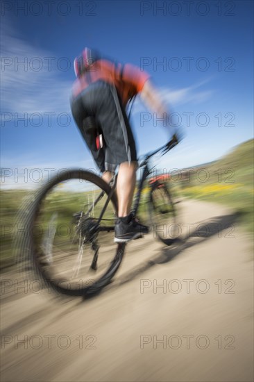 Blurred view of man riding mountain bike