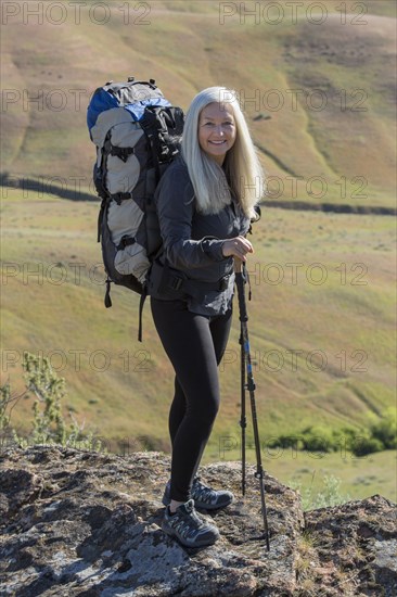 Older Caucasian woman hiking with backpack