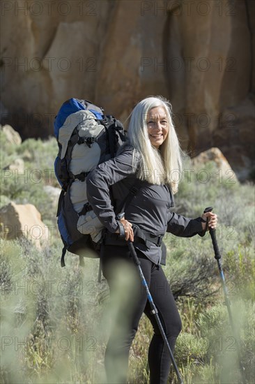 Older Caucasian woman hiking with backpack