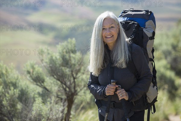 Older Caucasian woman hiking with backpack